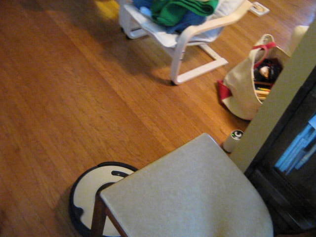 a baby's white high chair is sitting in the middle of the room