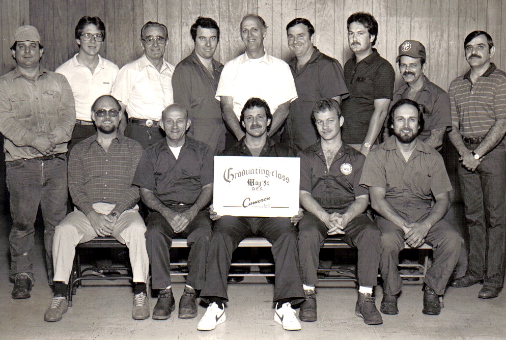 a group of men in suits pose on a bench