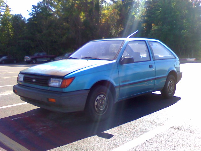 blue ford capri sedan in a parking lot