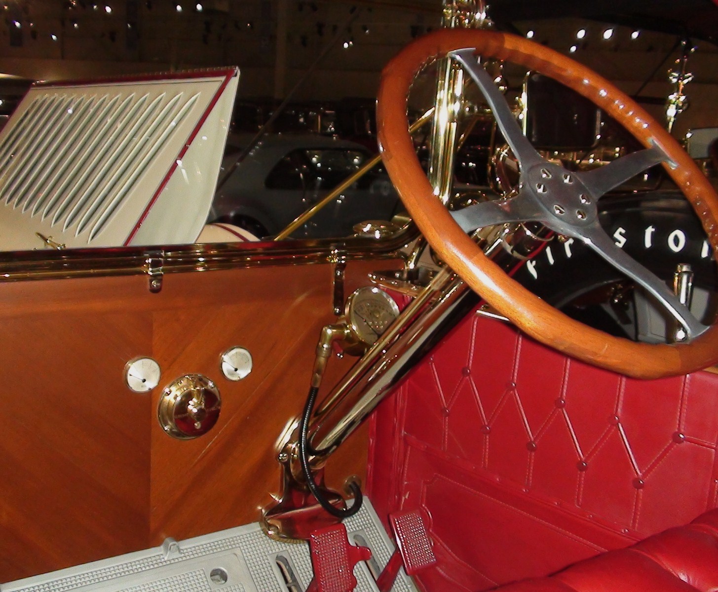 an old model car with a wooden steering wheel