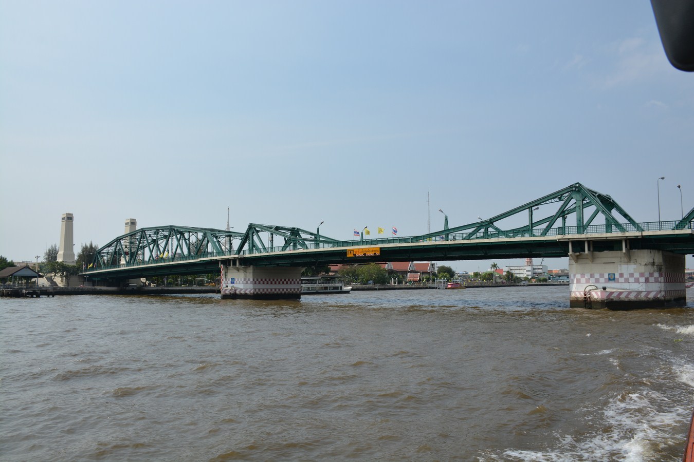 a bridge over water that has a train going over it