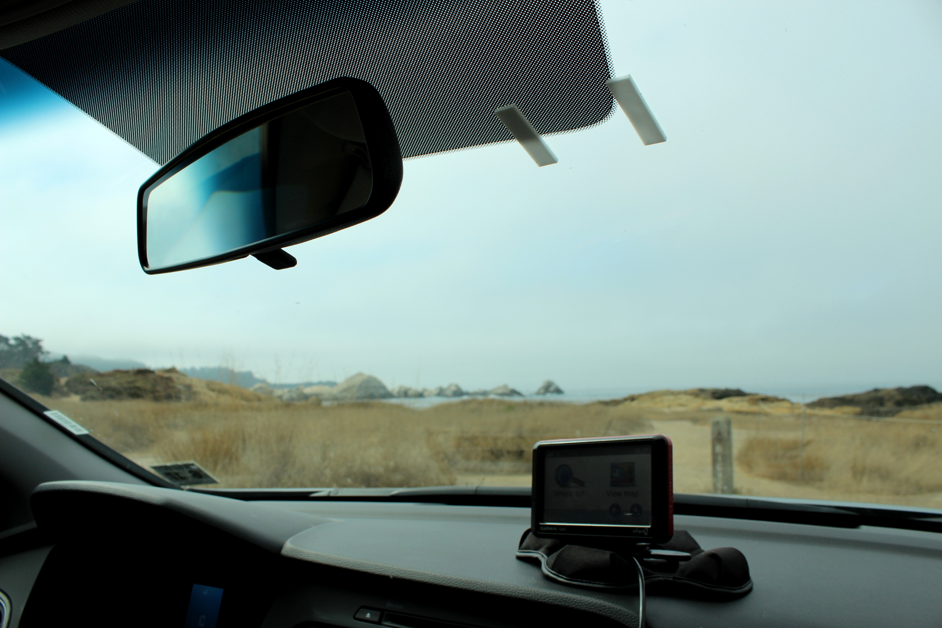 a car dashboard with a monitor on top of it