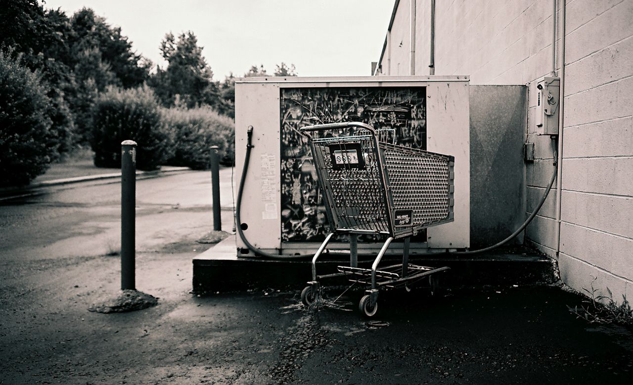 a black and white po of a shopping cart on a roadside