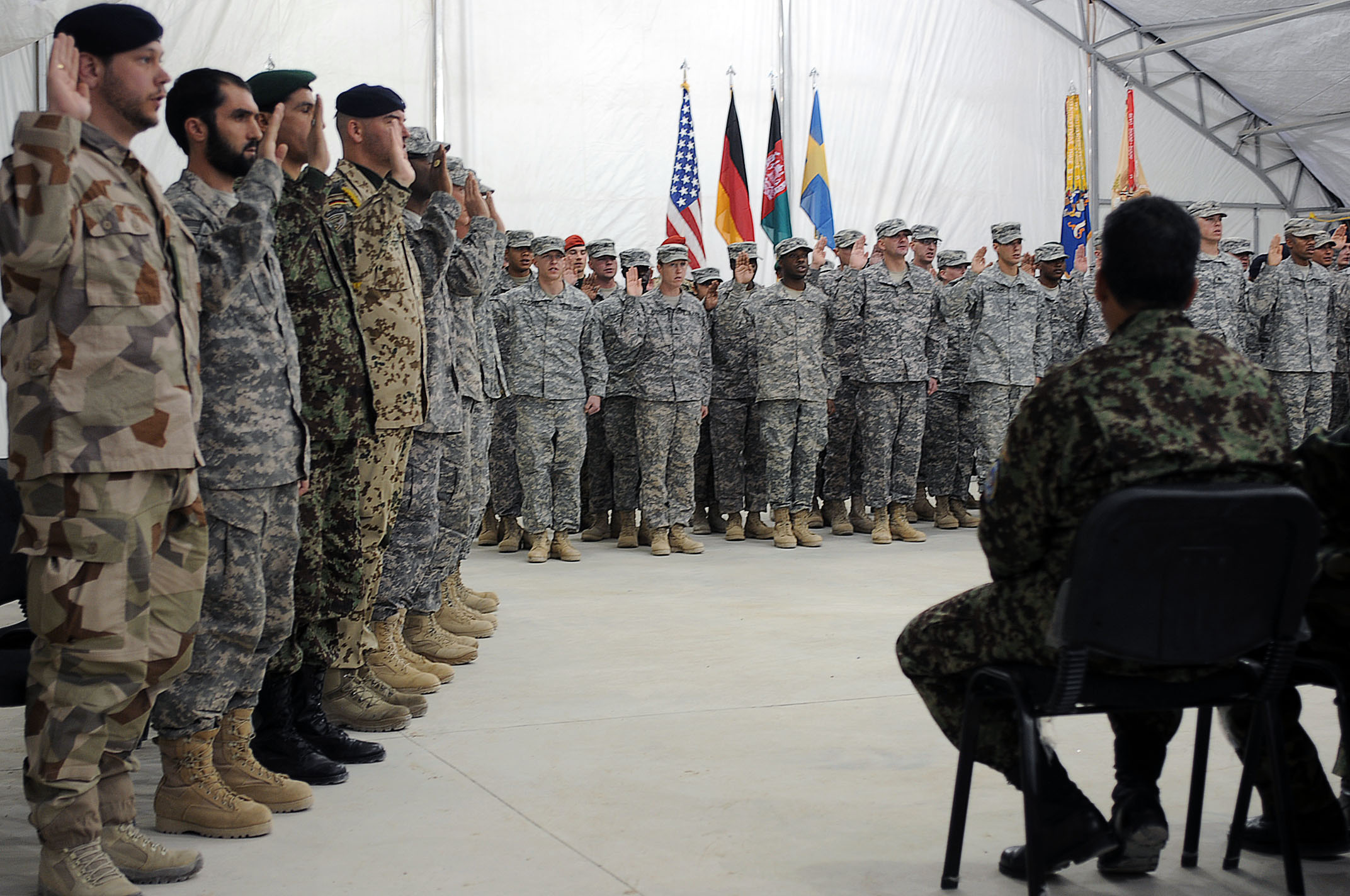 many soldiers with flags and a large group of men in uniform