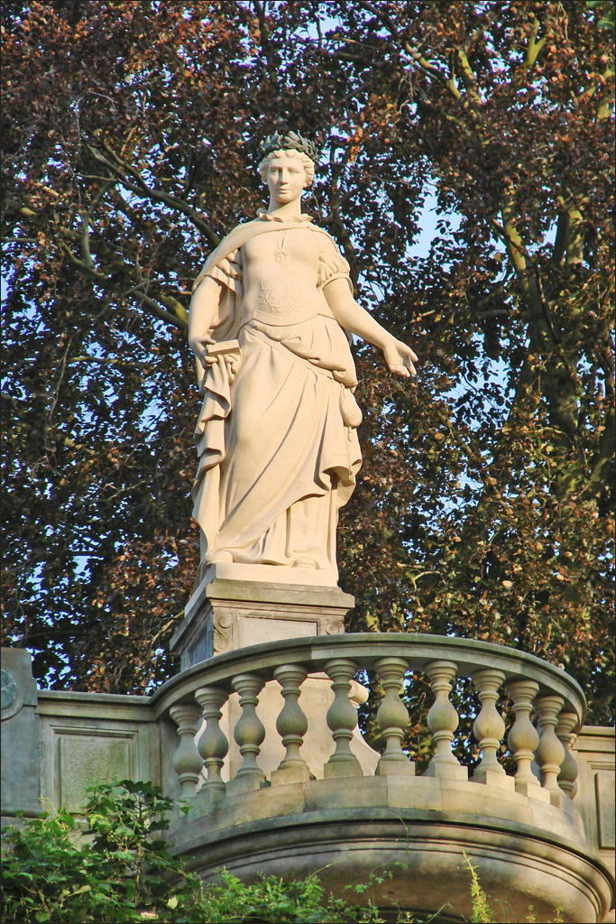 a statue of woman with a white skirt and arm around