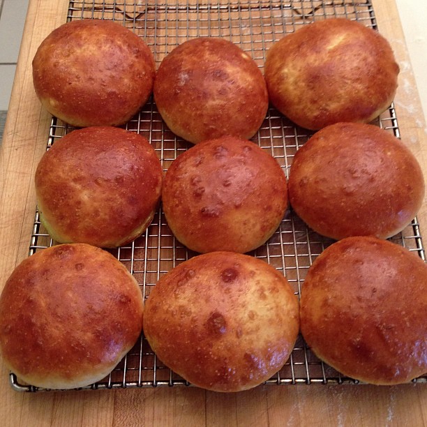 seven rolls on a cooling rack ready to be baked