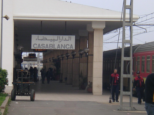 people walking in and out of an open train station