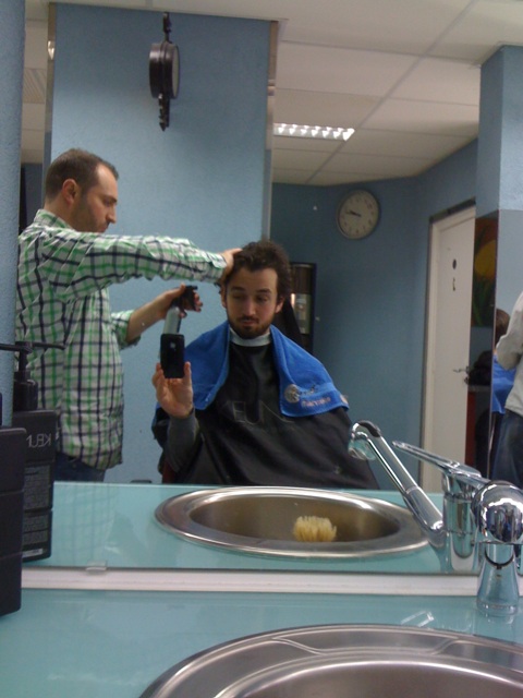 a man that is in a sink getting a haircut