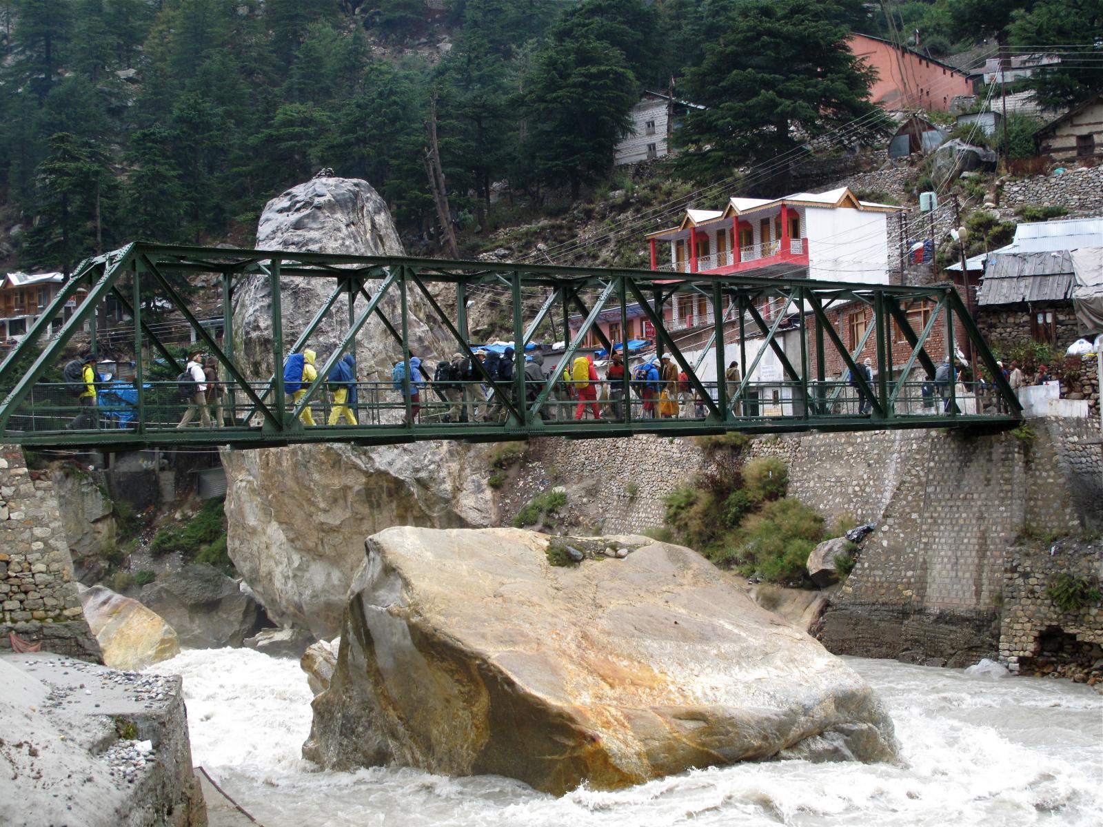 a bridge over some water with people standing on it