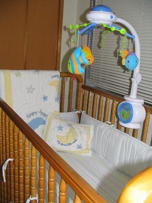 a baby crib is filled with toys like a rocking chair and cot