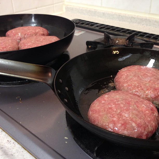 hamburgers are being cooked in a set on the stove