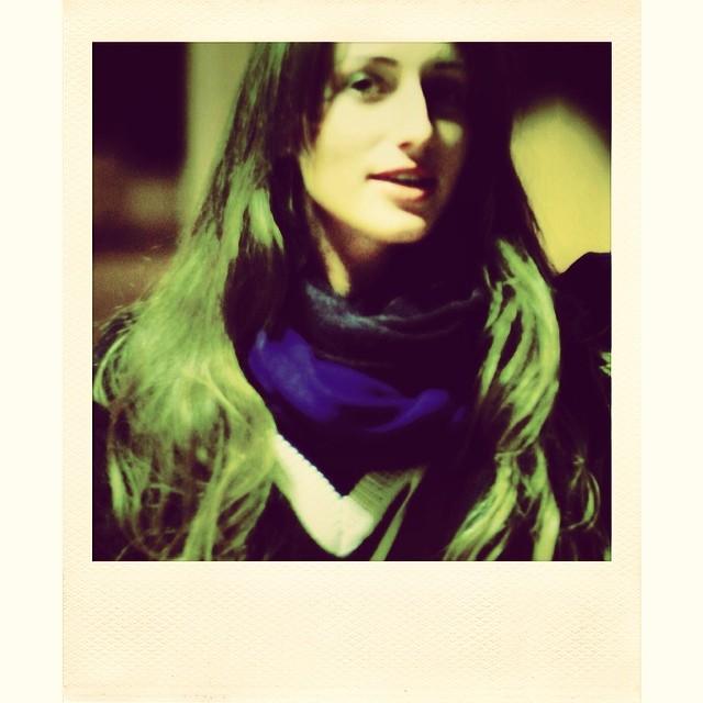a woman with long hair wearing a blue scarf