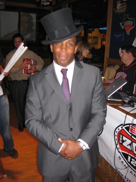 a man in a gray suit and top hat