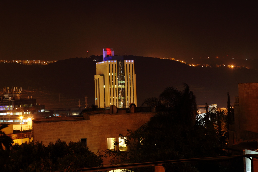 the large tall building has lights on it's side