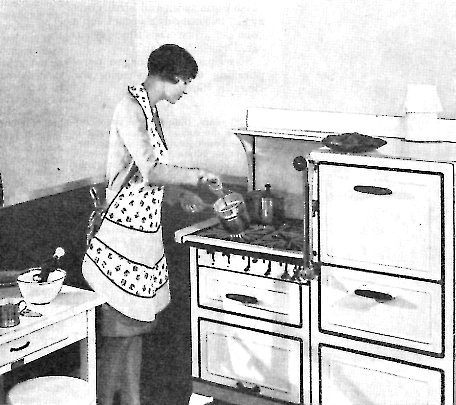 a woman in an apron looking at an oven