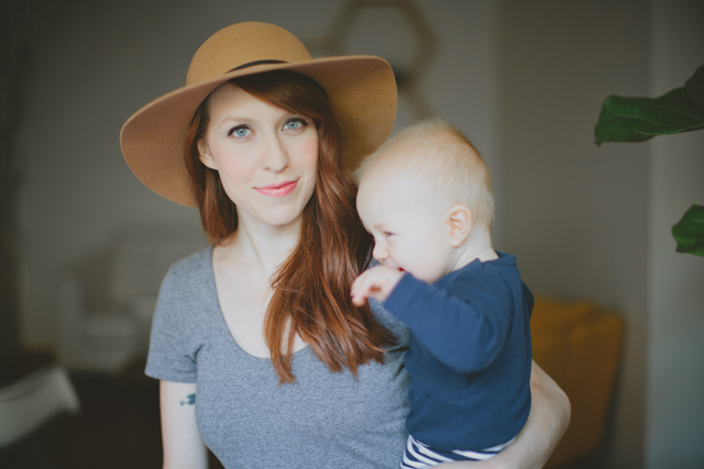 woman holding her baby boy in a hat