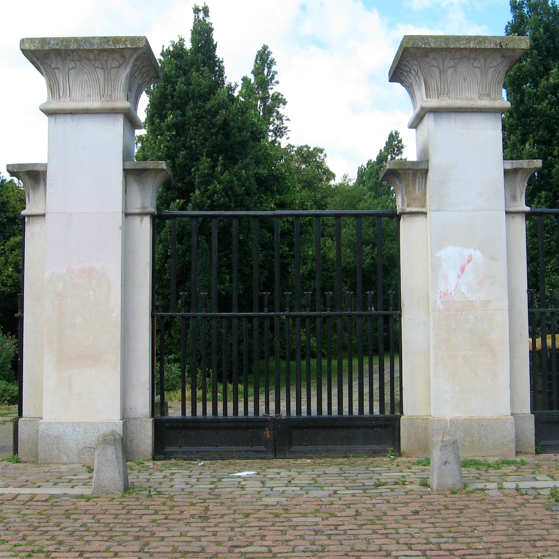 the gate to a garden area has two pillars
