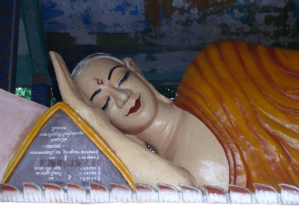 the buddha statue is resting its head on his hand