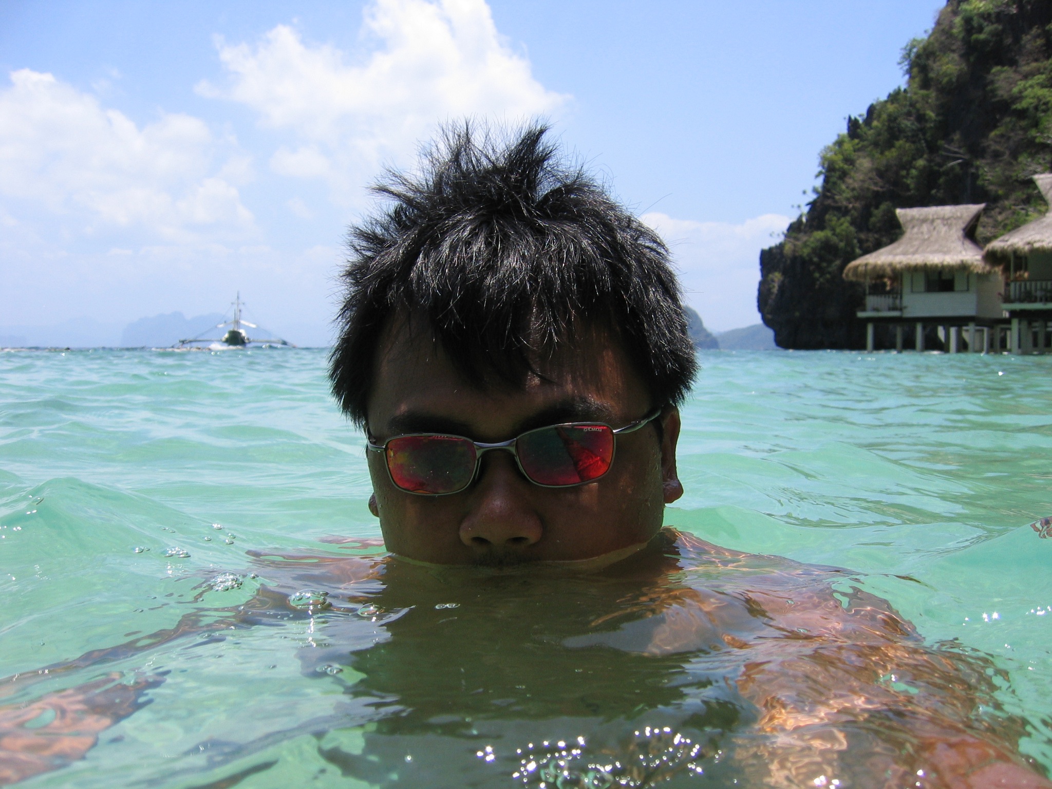 a guy swimming in some crystal clear water