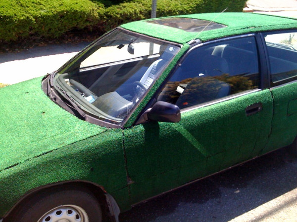 an old car with a very shiny green body