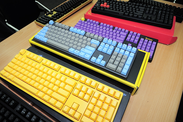 three different keyboards are sitting on a table
