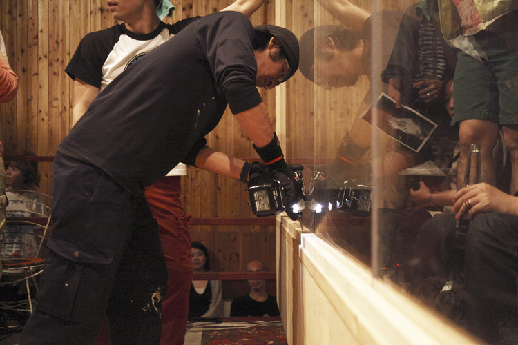 a man standing by a counter with a camera
