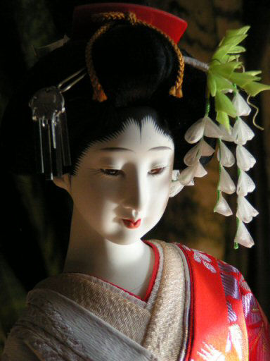 a close up view of a japanese doll head