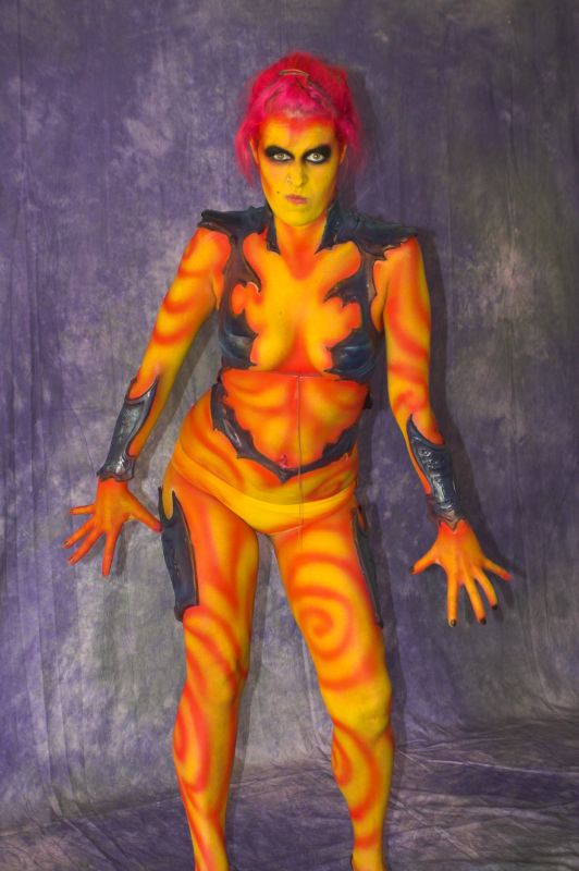 an orange and black person dressed in body paint