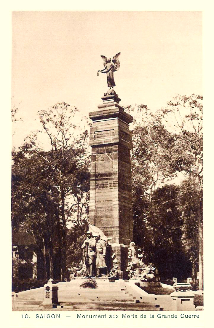 a statue in a park with a bird