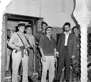 a black and white po of men standing in front of some doors