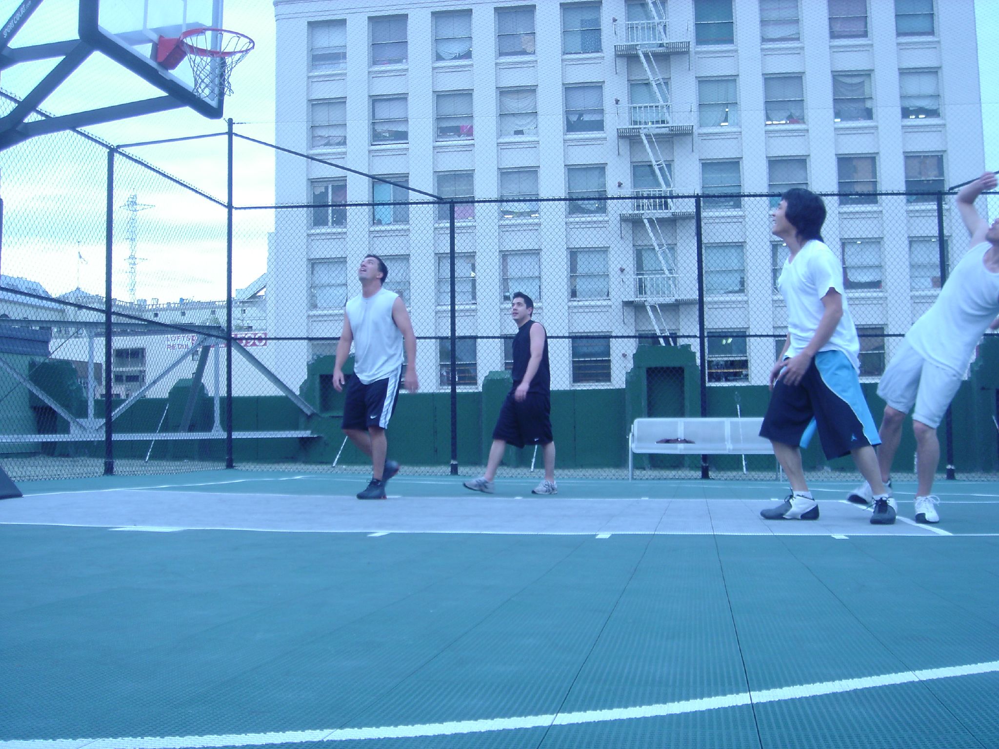 a group of men play basketball on a court