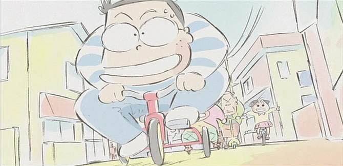 a person on a bike with buildings in the background