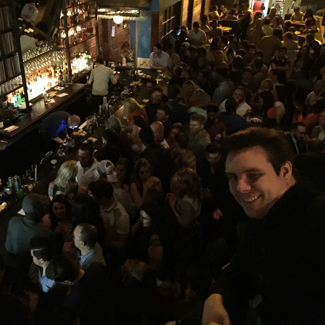 a crowded bar is filled with people drinking and drinking