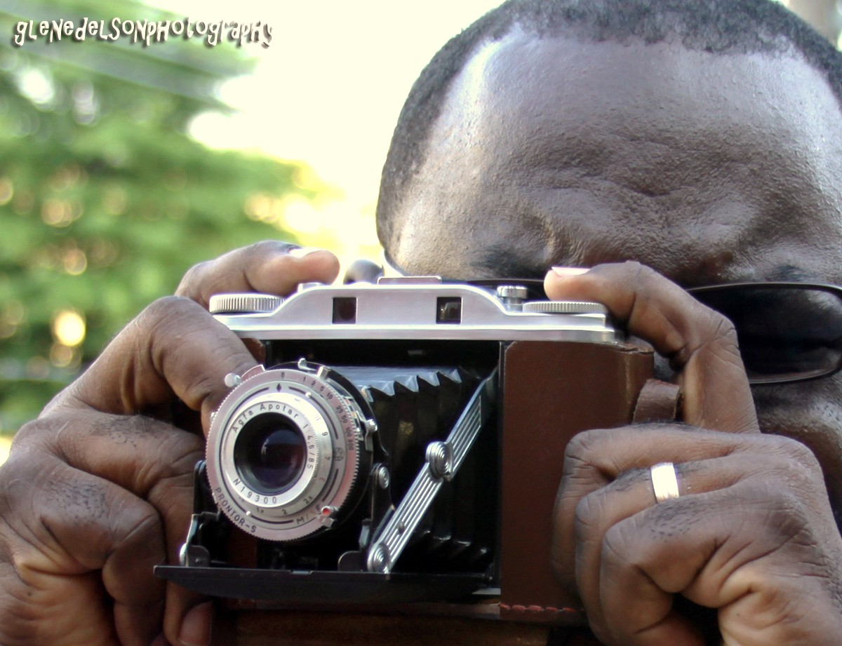 a man is holding an old style camera