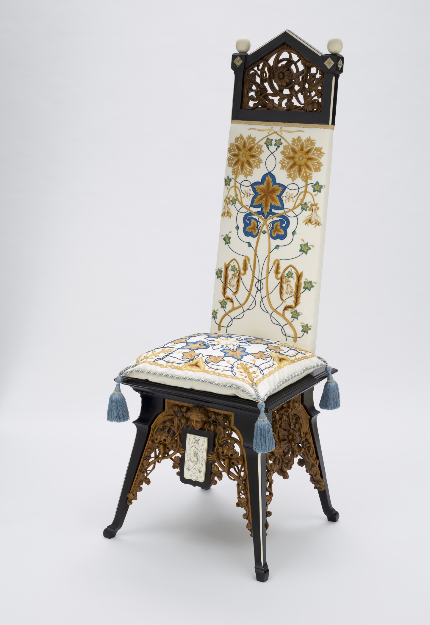 a chair with an ornate back and foot rest