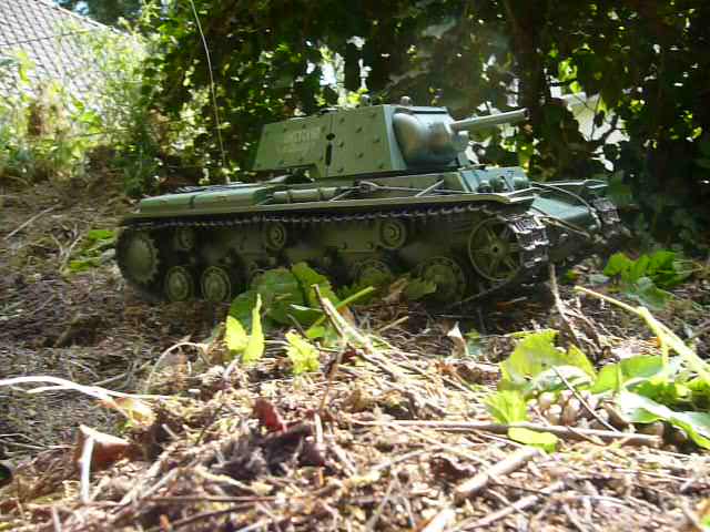 a toy model of a tank laying in the ground