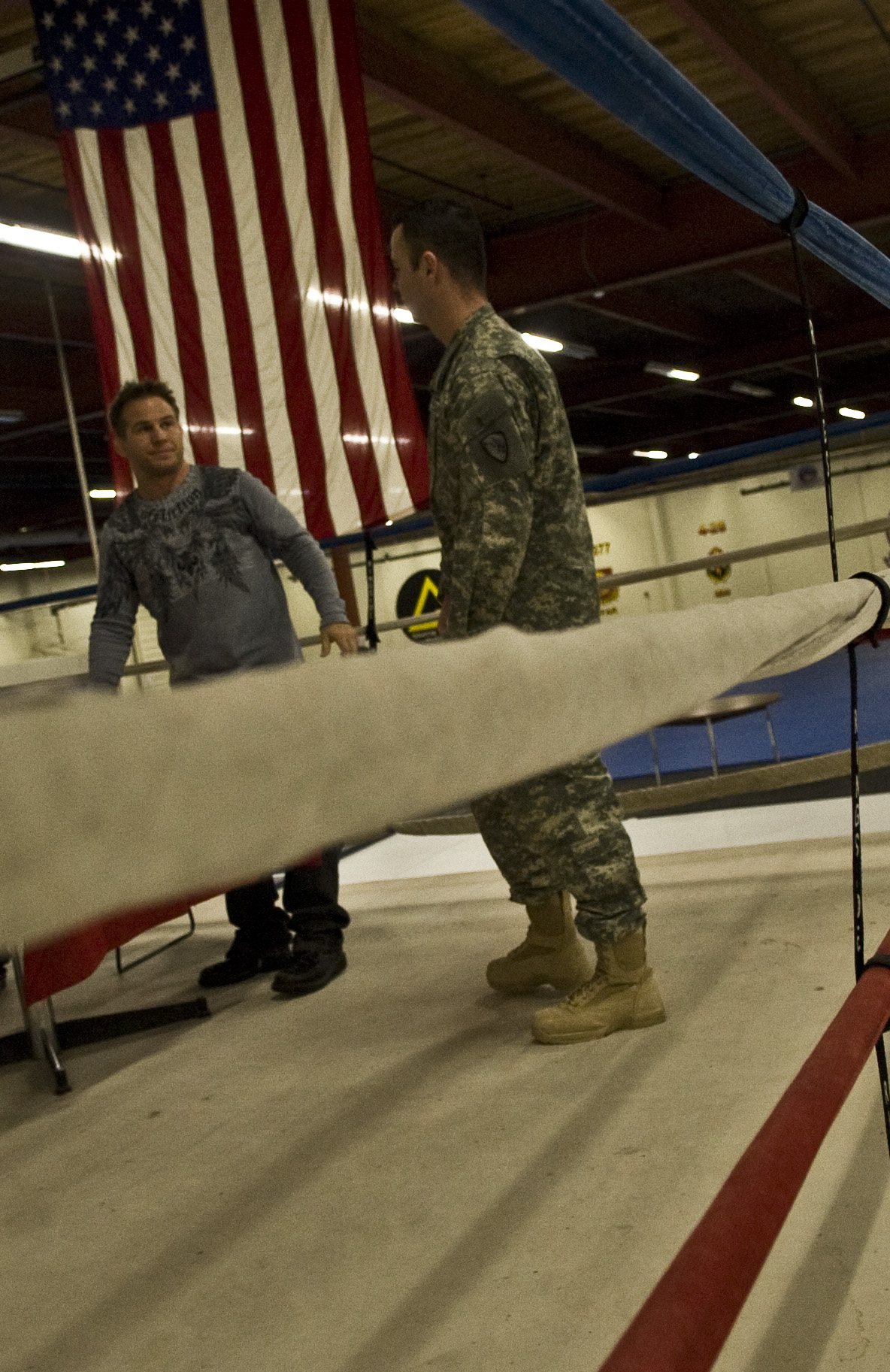 two soldiers are standing near an american flag