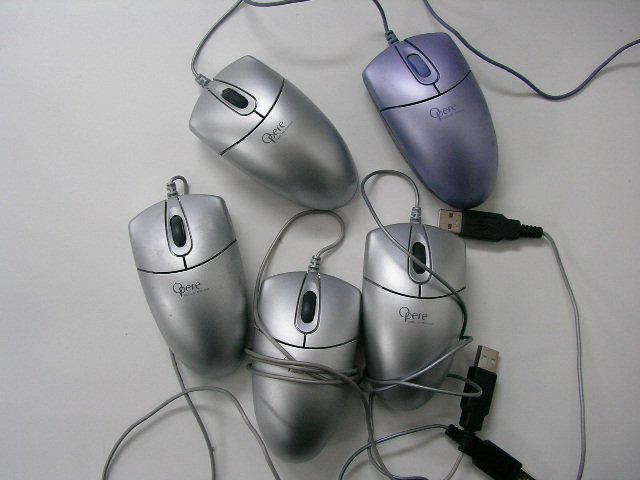 a group of computer mice surrounded by cords