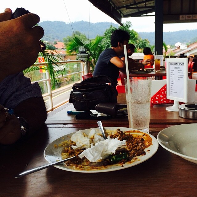 an over head picture of some food on a table with people and a drink