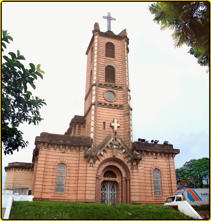 a tall church that has a cross on top
