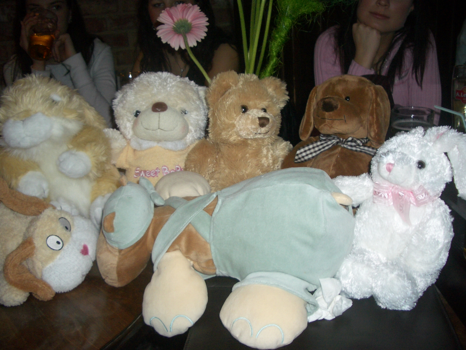 a pile of stuffed animals sitting on top of a wooden table