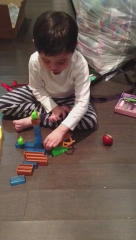 a young child plays with toys on the floor