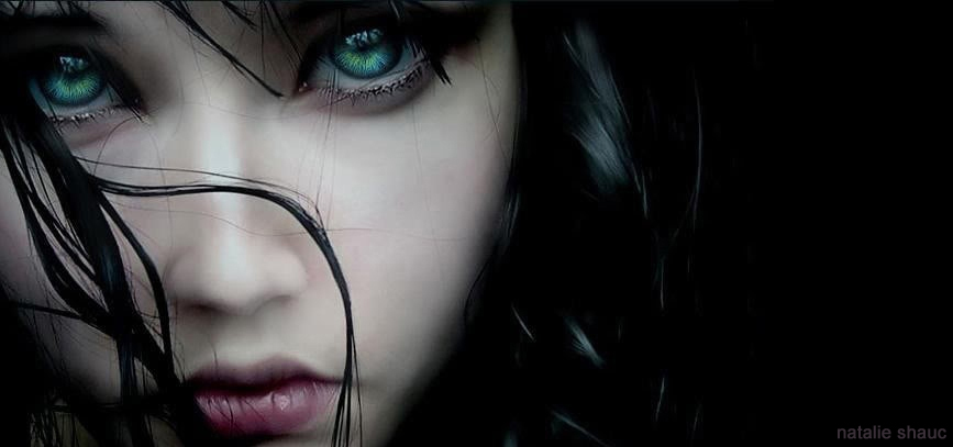 a close up of a woman's face with green eyes