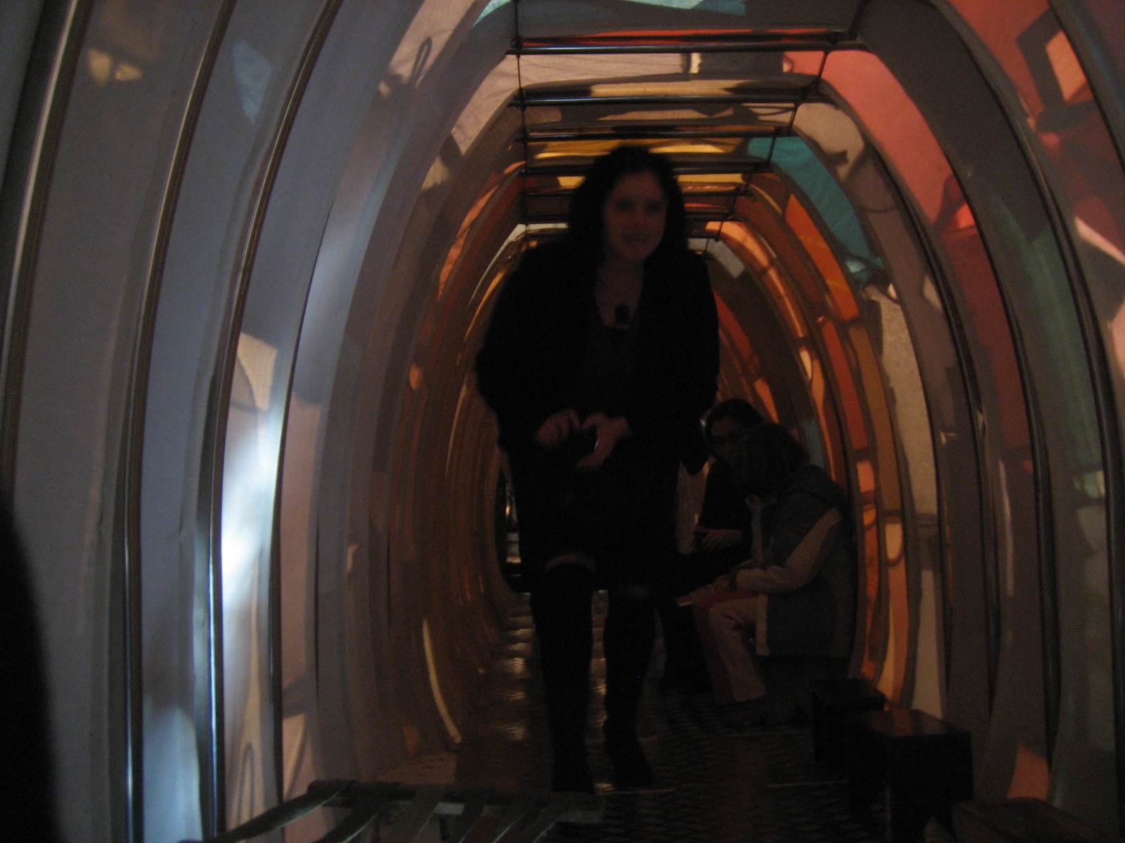 two woman are standing in an art deco tunnel