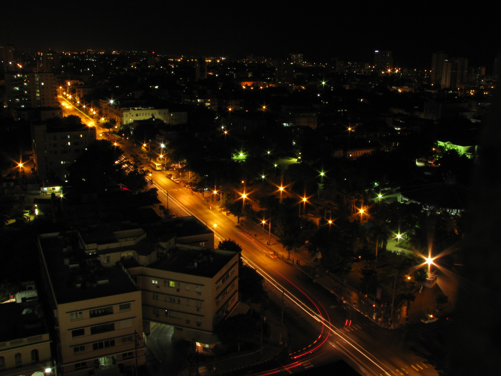an aerial view of city lights and street traffic