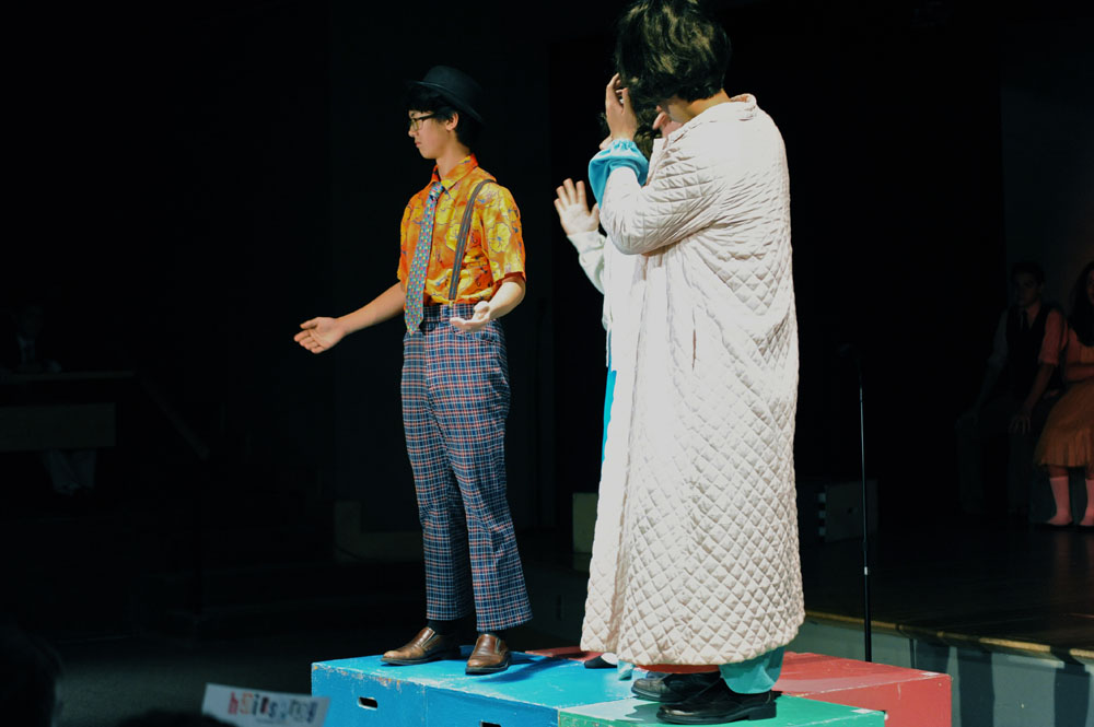 two people stand on the stage with each other