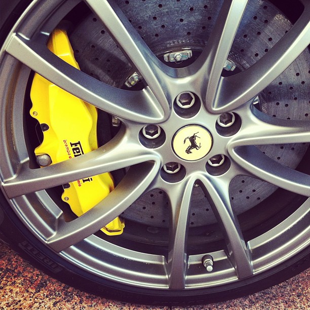 yellow ke pads on the rim of a sports car