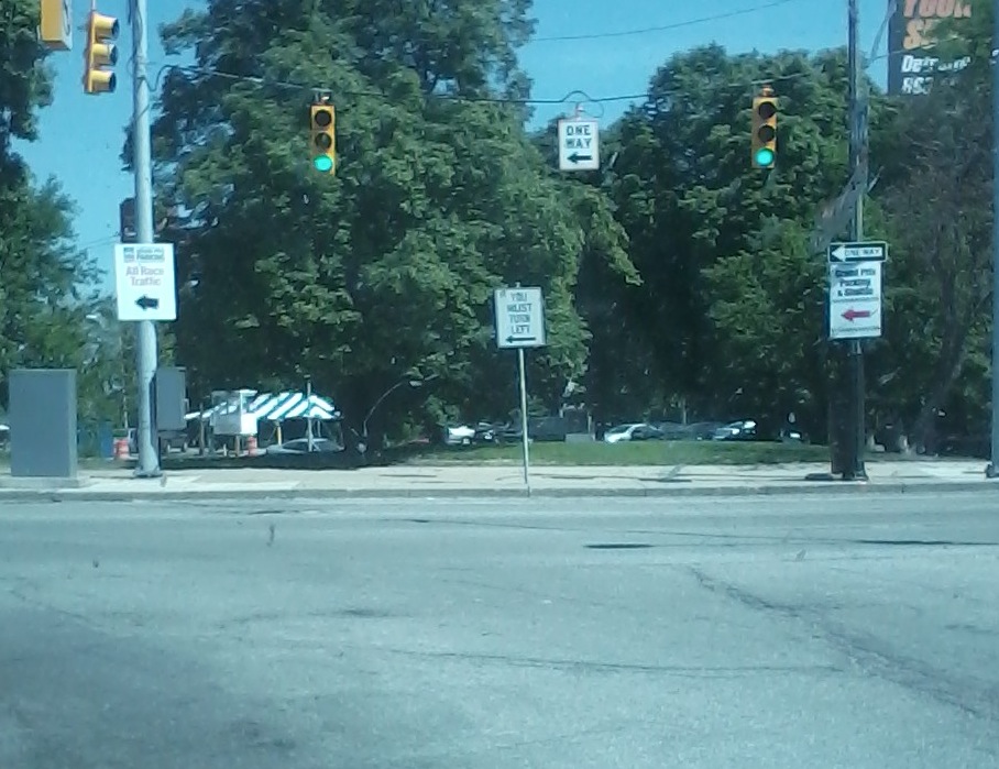 traffic signals hanging from poles on an intersection