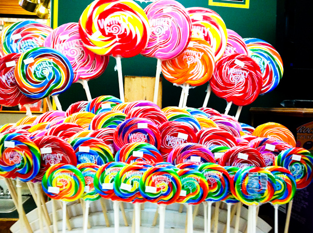 many different colored lollipops arranged on sticks