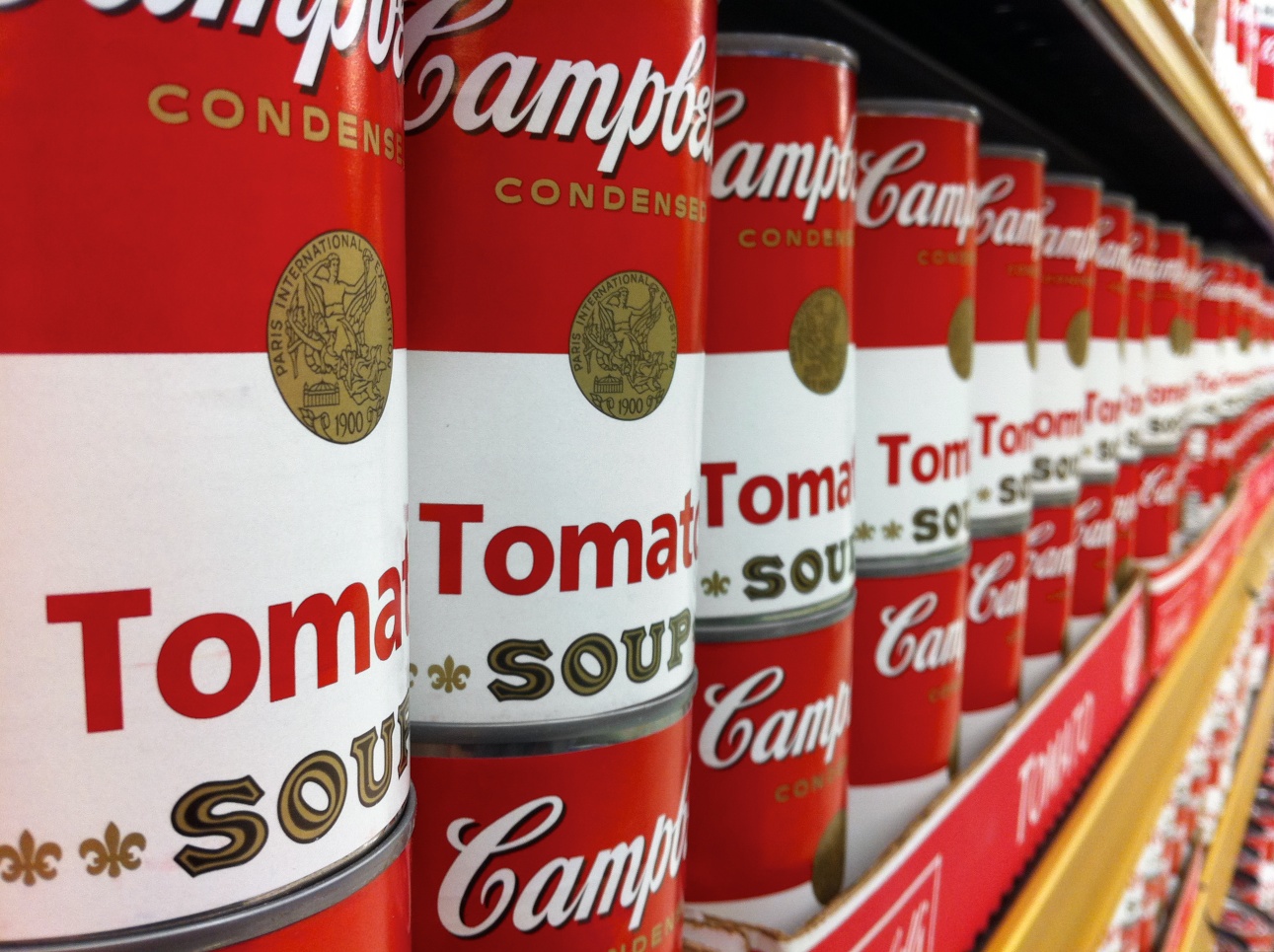 a row of cans that say campbell cola